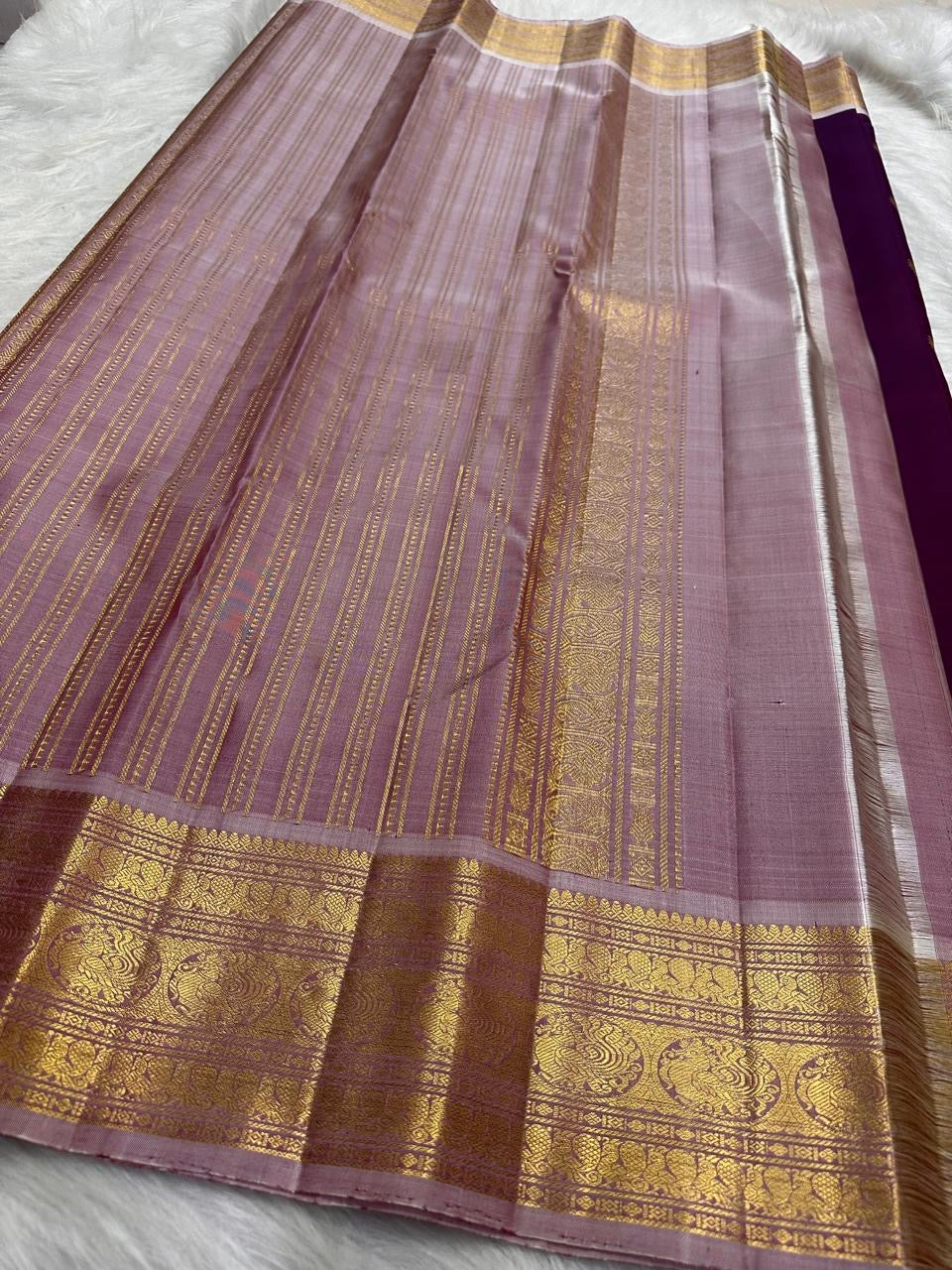Close-up of Mayil Kamalam antique gold zari Butta on KanchiPattu saree
