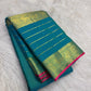 Close view of antique-gold traditional zari motifs woven on blue-green Kanjivaram silk.