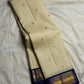 Close view of gold Mayil zari motifs woven across a deep blue-green Kanchipuram Korvai border.