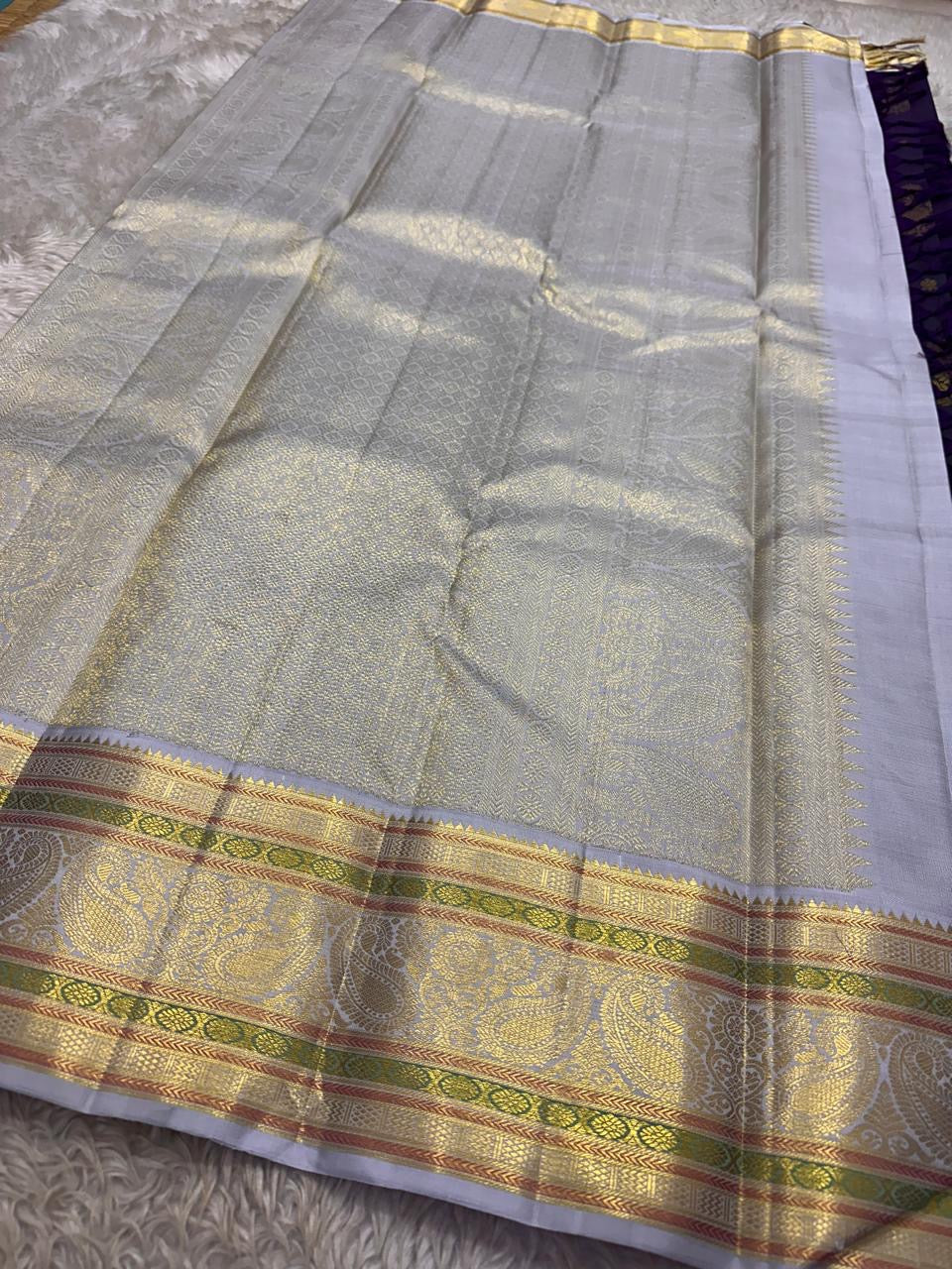 Peacock green purple shot Kanjivaram silk saree with petite gold Poo Buttas