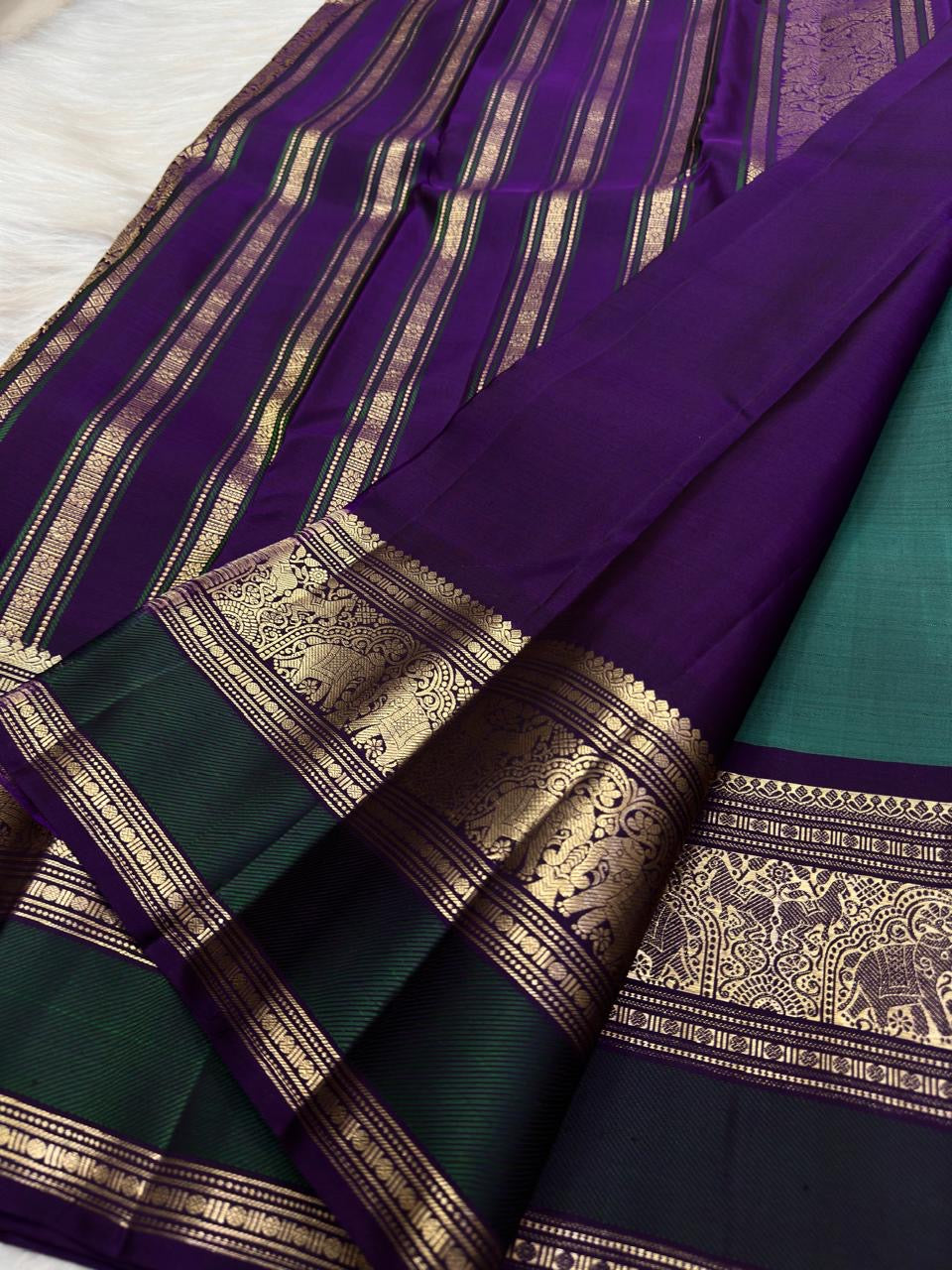 Handwoven blue-green Kanchipuram silk saree with antique gold zari buttas