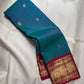 Mayil Kazhuthu Kanchipuram Saree — body close-up showing peacock-neck blue-green tone and gold zari buttas