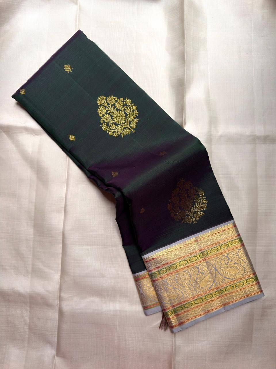 Silver-toned Maanga paisley zari border on Mayil Kazhuthu Pure Silk Kanchipuram