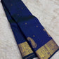 Intricate Mayil gold zari border on peacock blue-green Kanchipuram Butta saree