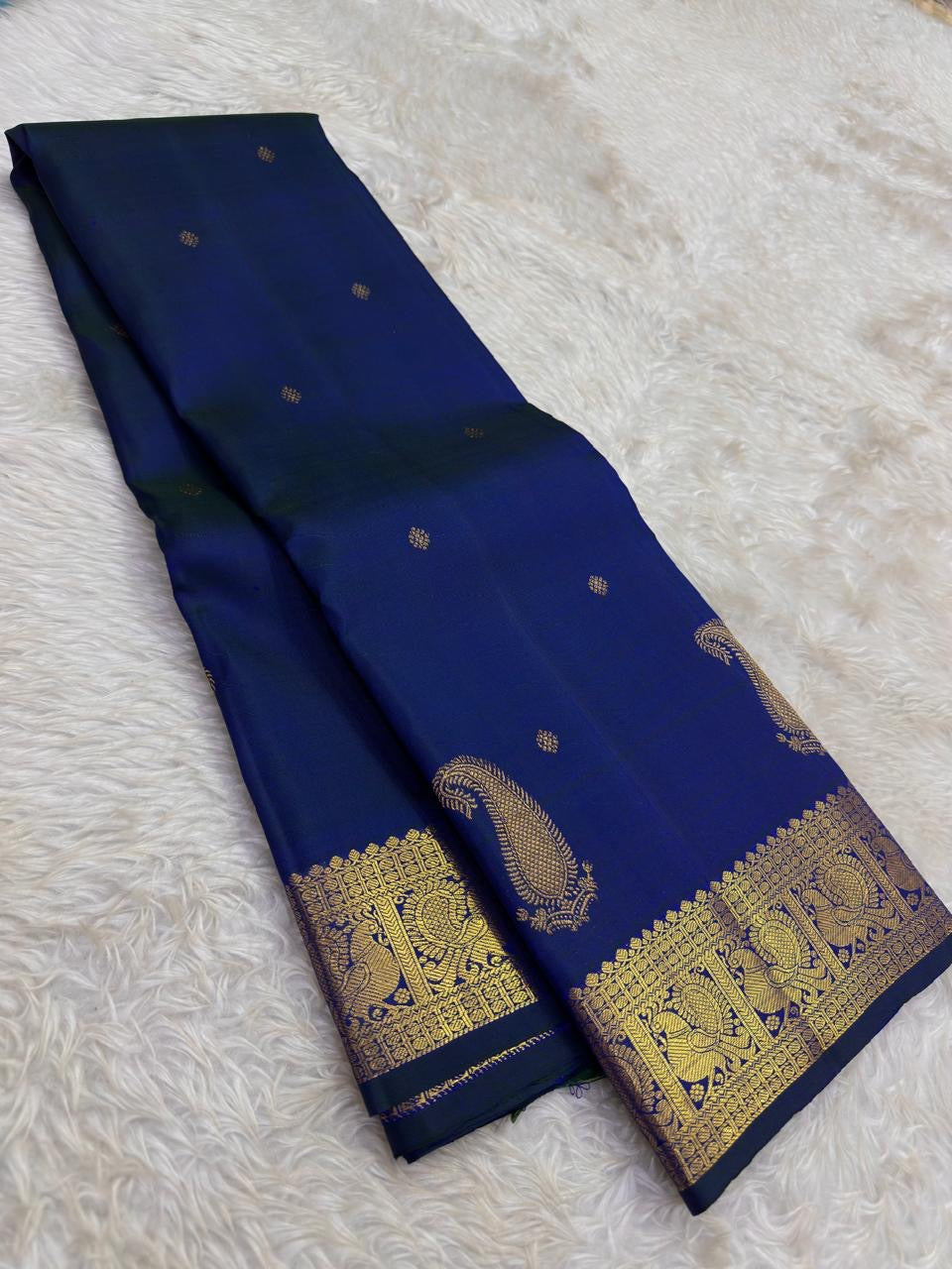 Intricate Mayil gold zari border on peacock blue-green Kanchipuram Butta saree