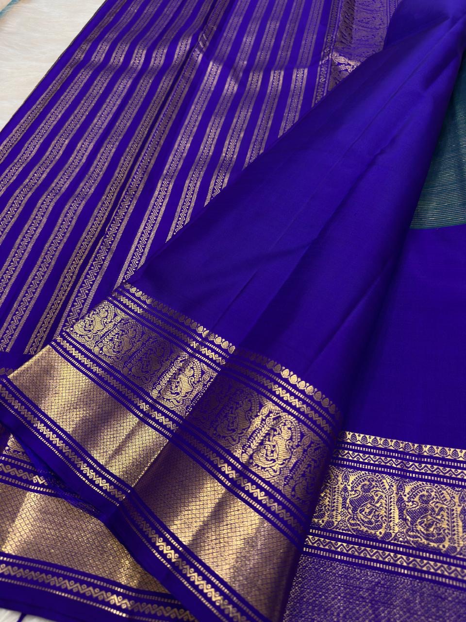 Traditional Mayil peacock border in antique gold on Royal Purple Kanjivaram silk.