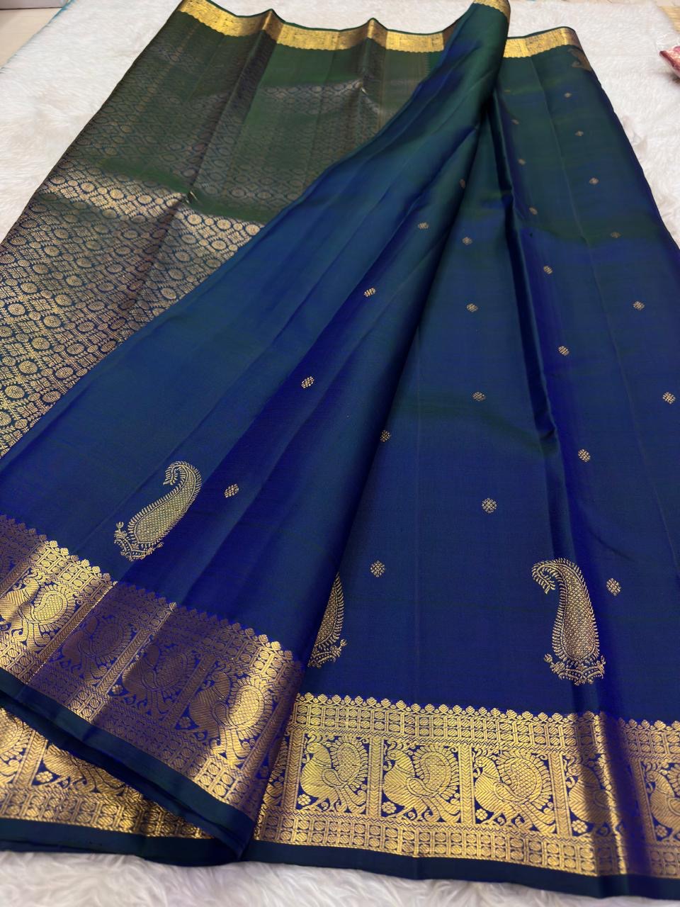 Peacock blue-green Kanchipuram silk saree with petite gold buttas and intricate Mayil zari border