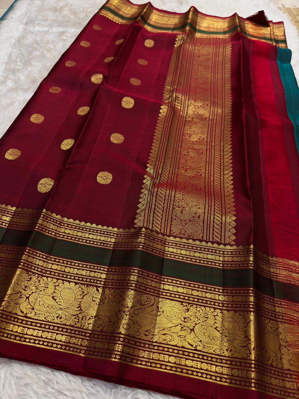 Close view of ceremonial elephant zari buttas woven on the peacock-neck teal silk