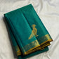 Close view of large antique-gold traditional bird motif on blue-green Kanchipuram silk.