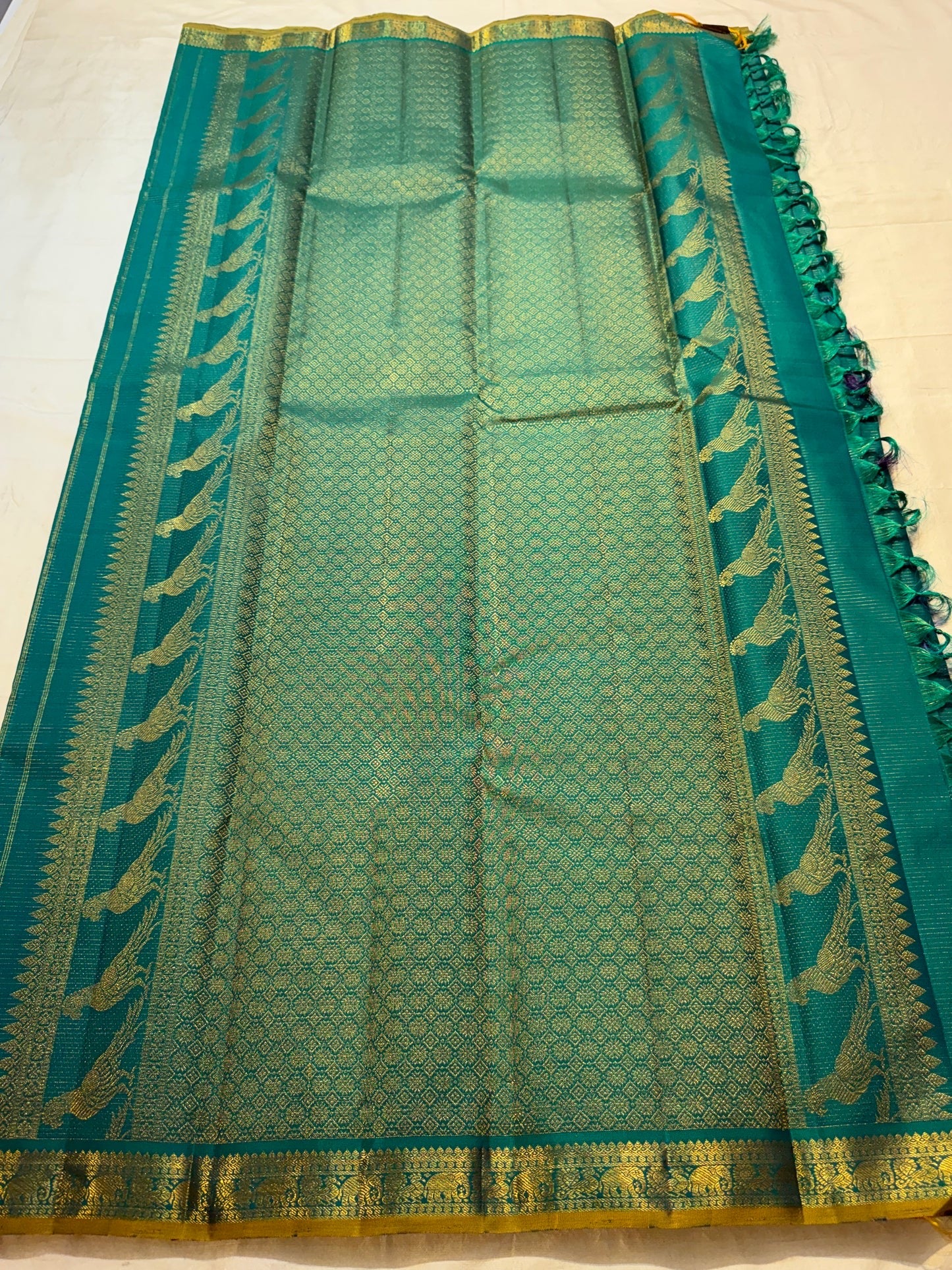 Mayil Kazhuthu blue-green pure silk Kanchipuram Vairaoosi saree with fine antique-gold zari lines.
