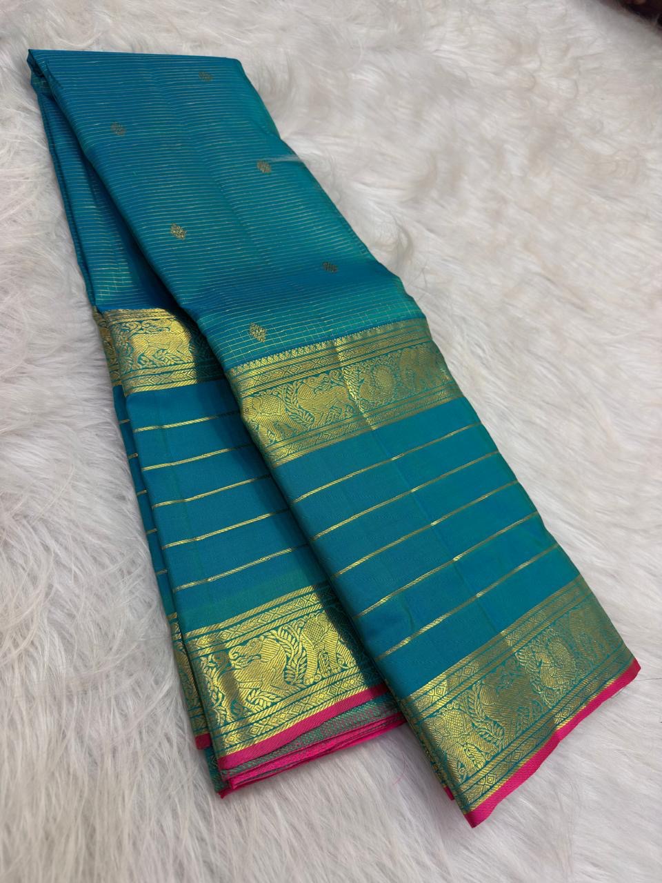Mayil Kazhuthu Blue-Green pure silk Kanjivaram Varisaipet saree with antique-gold zari border.