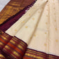 Mayil peacock and Thazampoo screwpine-flower motifs, warm-ivory Kanjivaram saree