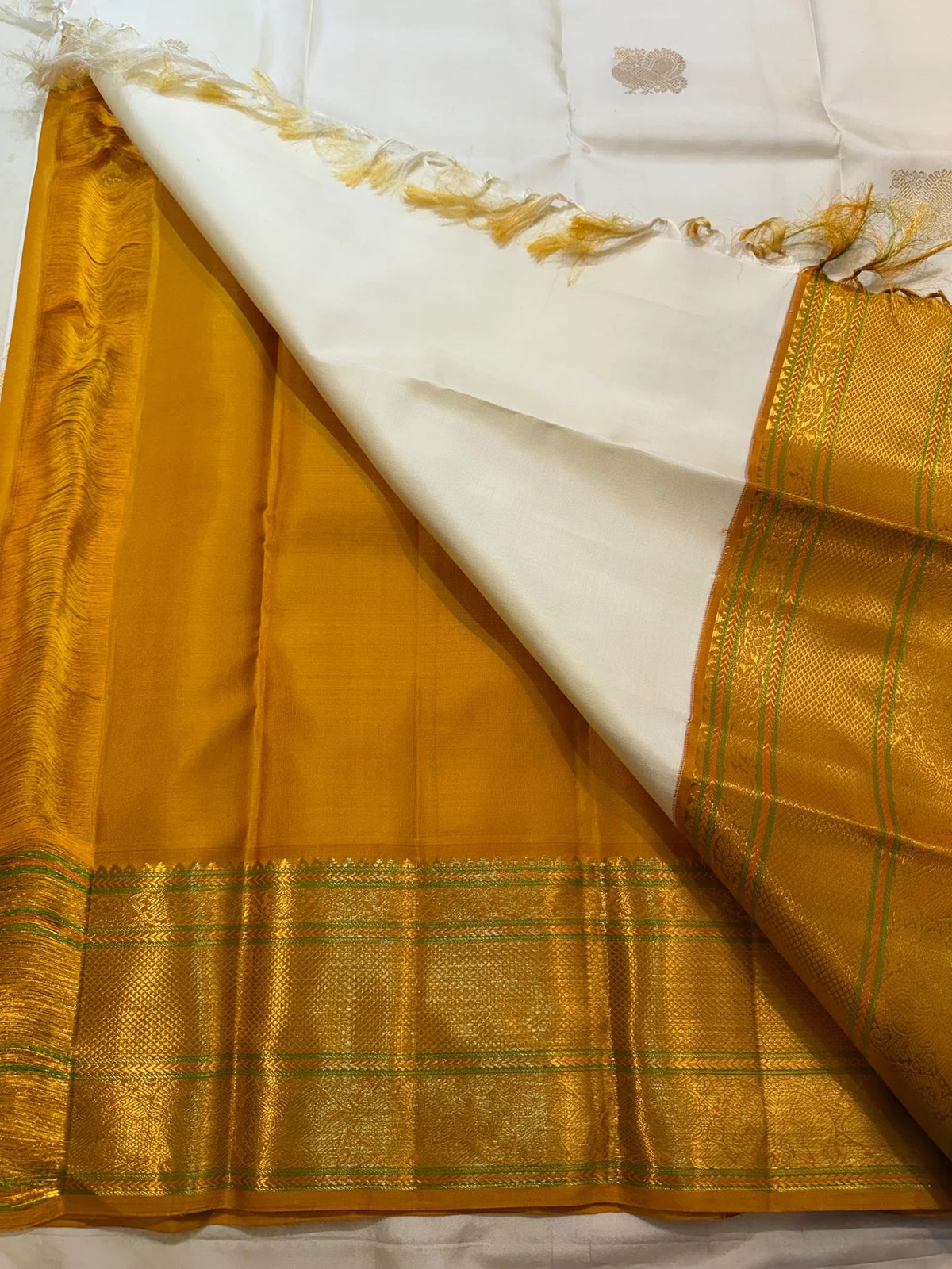 Warm Ivory Kanchipuram saree with Golden Harvest Mustard pallu