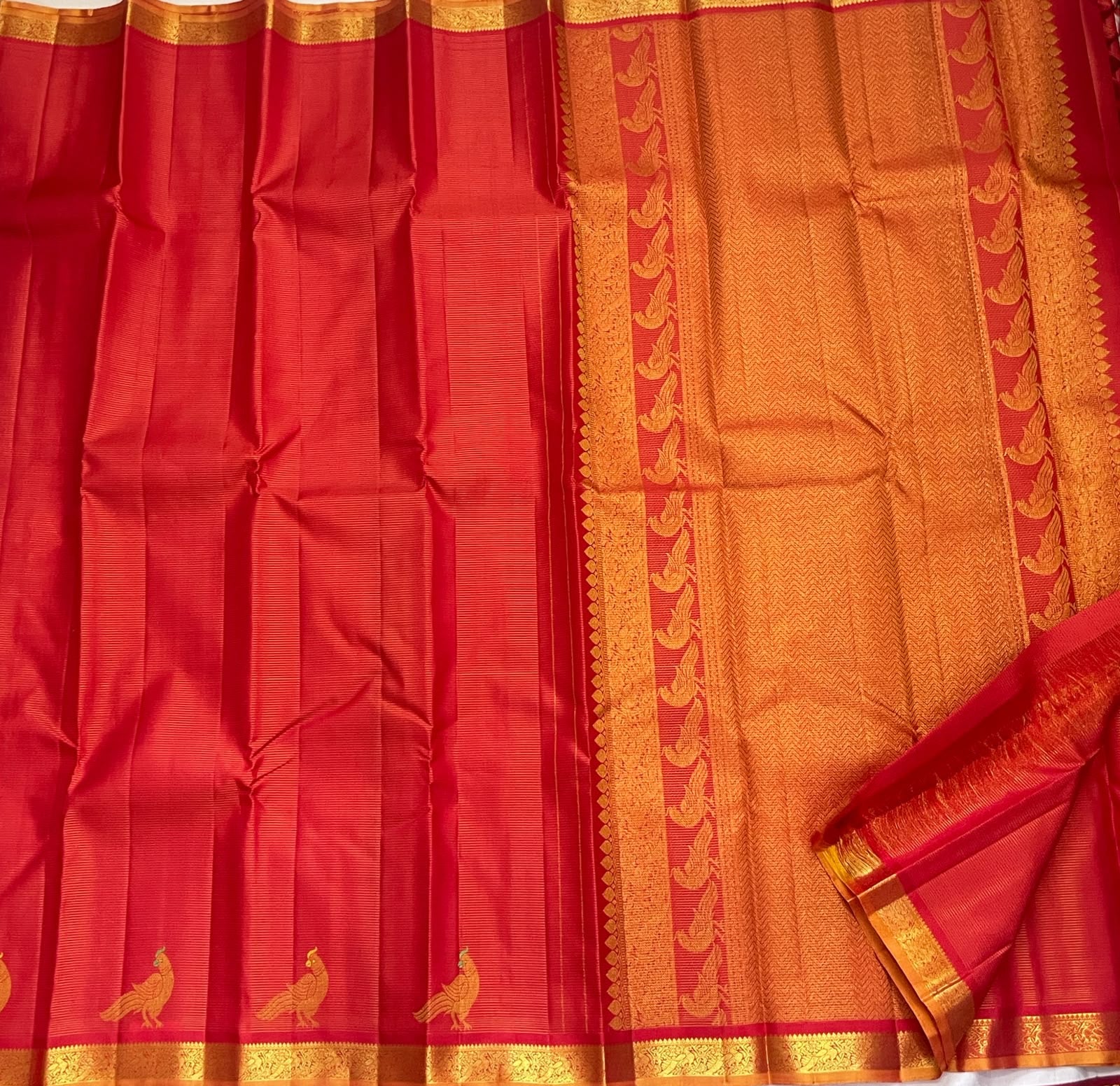 Mayil zari motif detail on the vermilion red Vairaoosi Kanchipuram saree