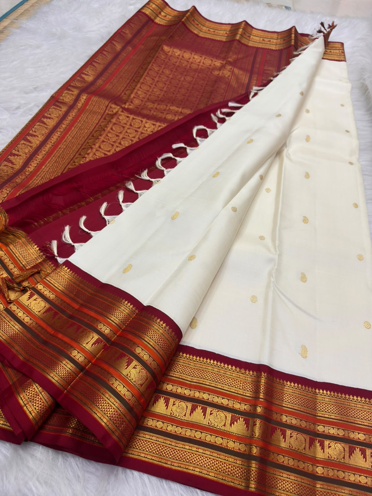 Mayilkann peacock-eye and Mayilpet peacock panels, warm-ivory Kanchipuram Korvai saree