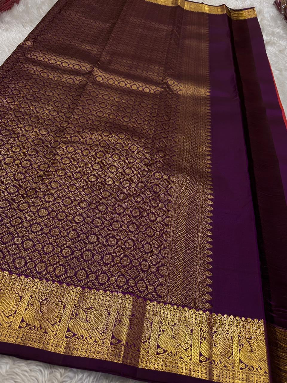 Kanchipattu silk saree in royal purple with antique gold border Maanga Butta weave traditional zari detail