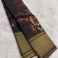 Handwoven black Kanchipuram Butta saree with burgundy peach sage and gold floral zari work.