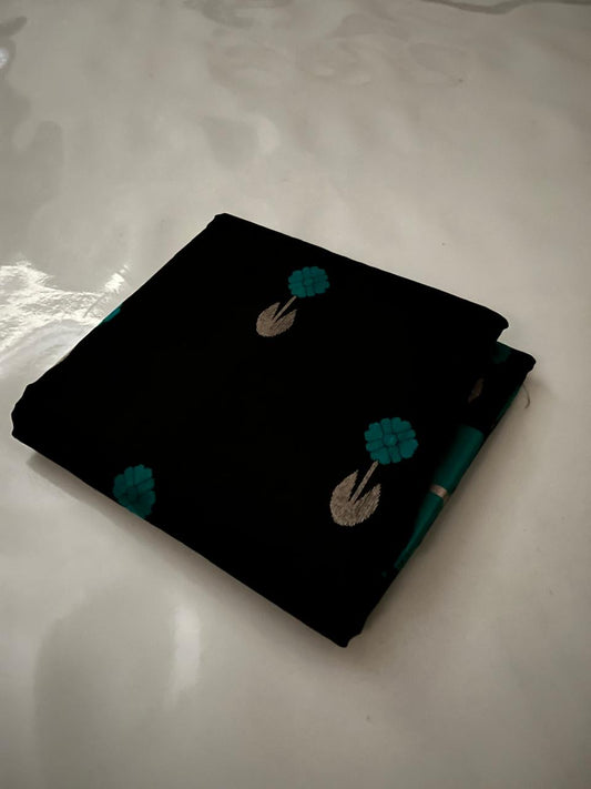 Close view of midnight-black Pattu Silk Chanderi saree body with peacock-teal accents