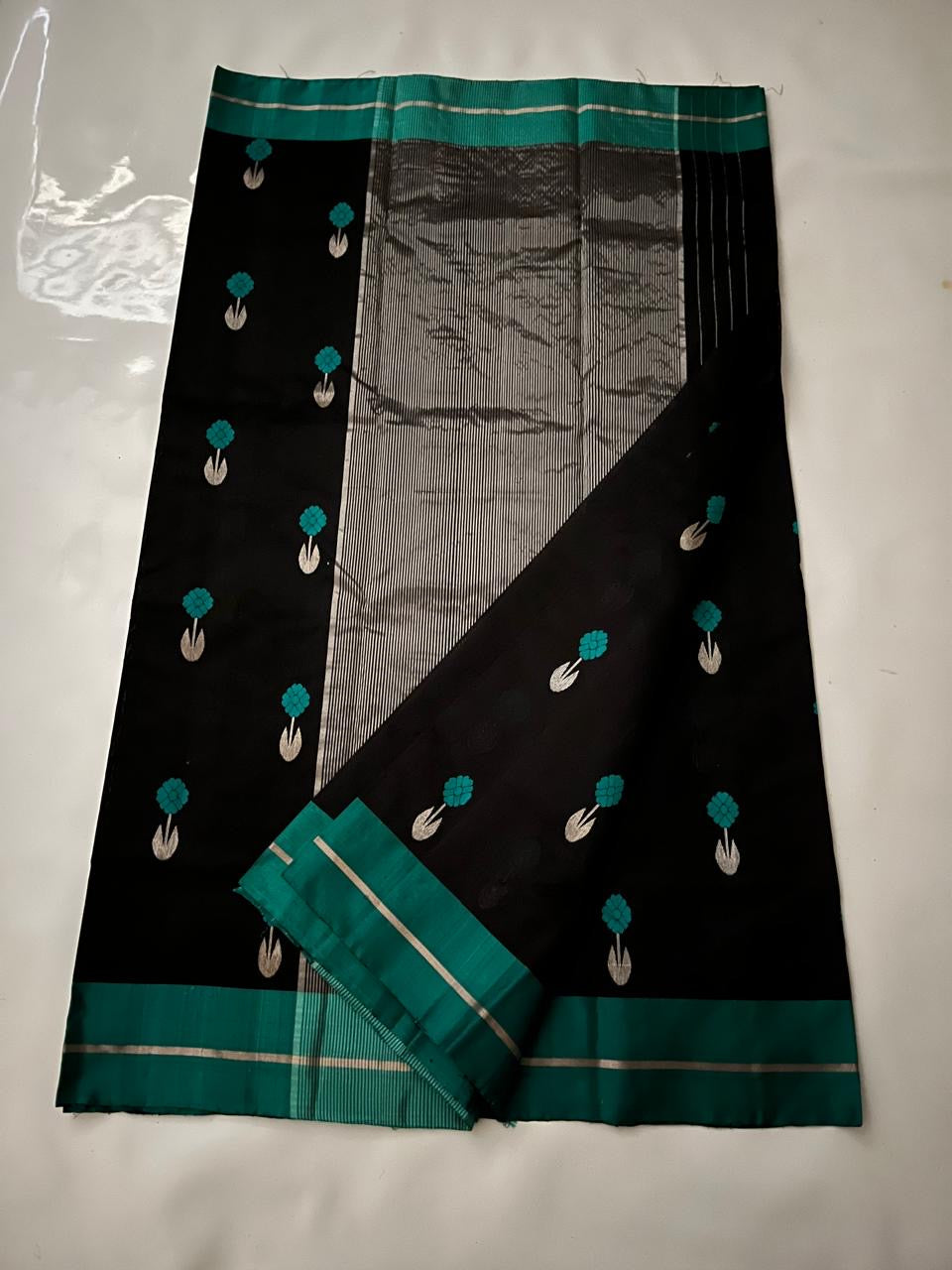 Black Pattu Silk Chanderi saree with peacock-teal borders and silver-toned pallu