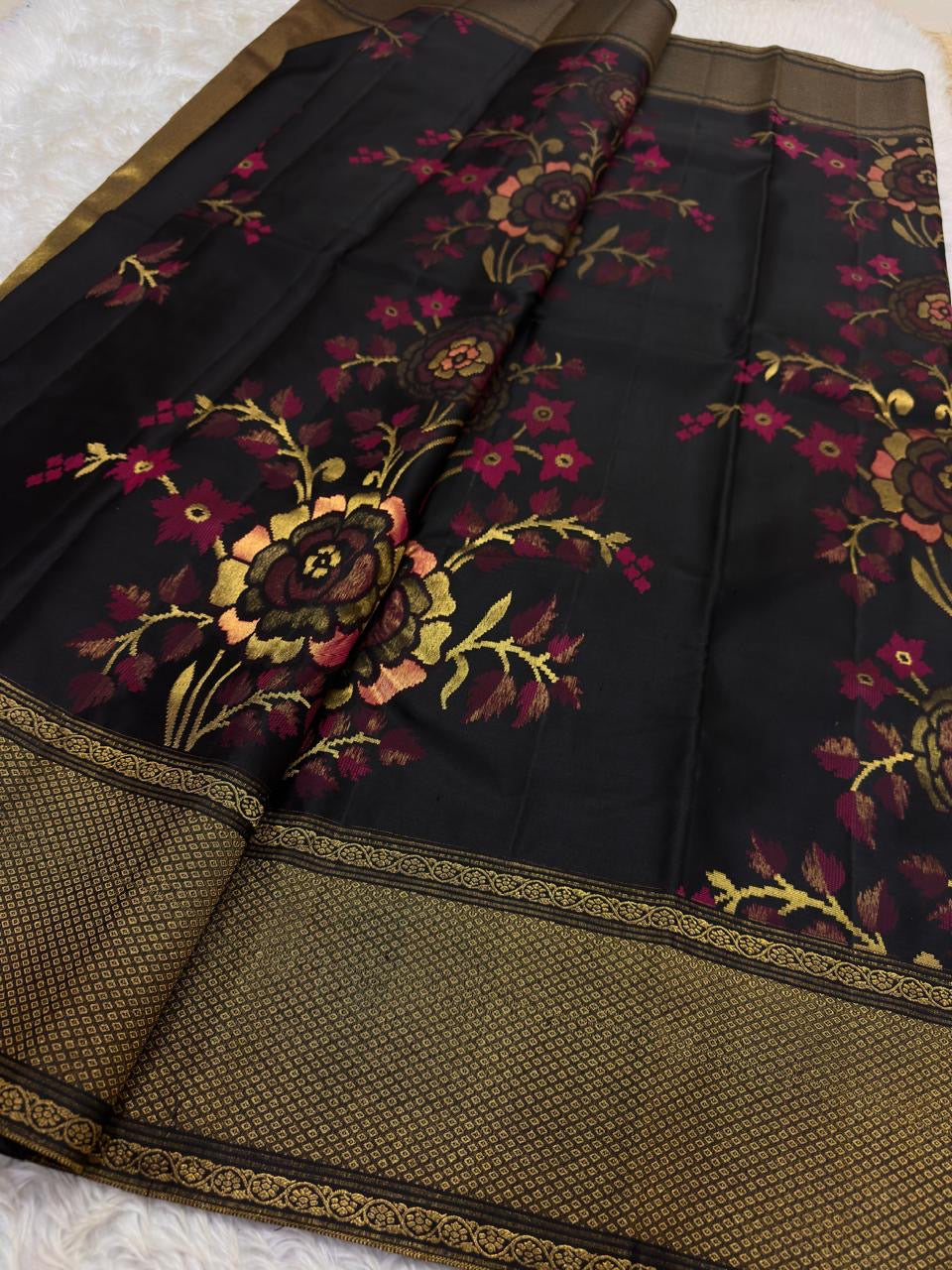 Black Kanchipuram silk saree with raspberry rose olive and antique-gold handwoven floral motifs.