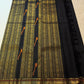 Self-colour black border with layered gold-zari bands and ornamental floral / paisley-like detailing.