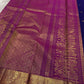 Vadamalli magenta-purple contrast border against the deep indigo KanchiPattu silk body.