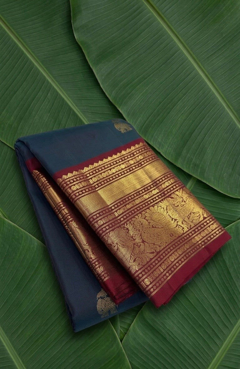 Midnight navy blue Korvai Kancheepuram silk saree with burgundy red border and yaanai ambari butta – front drape view