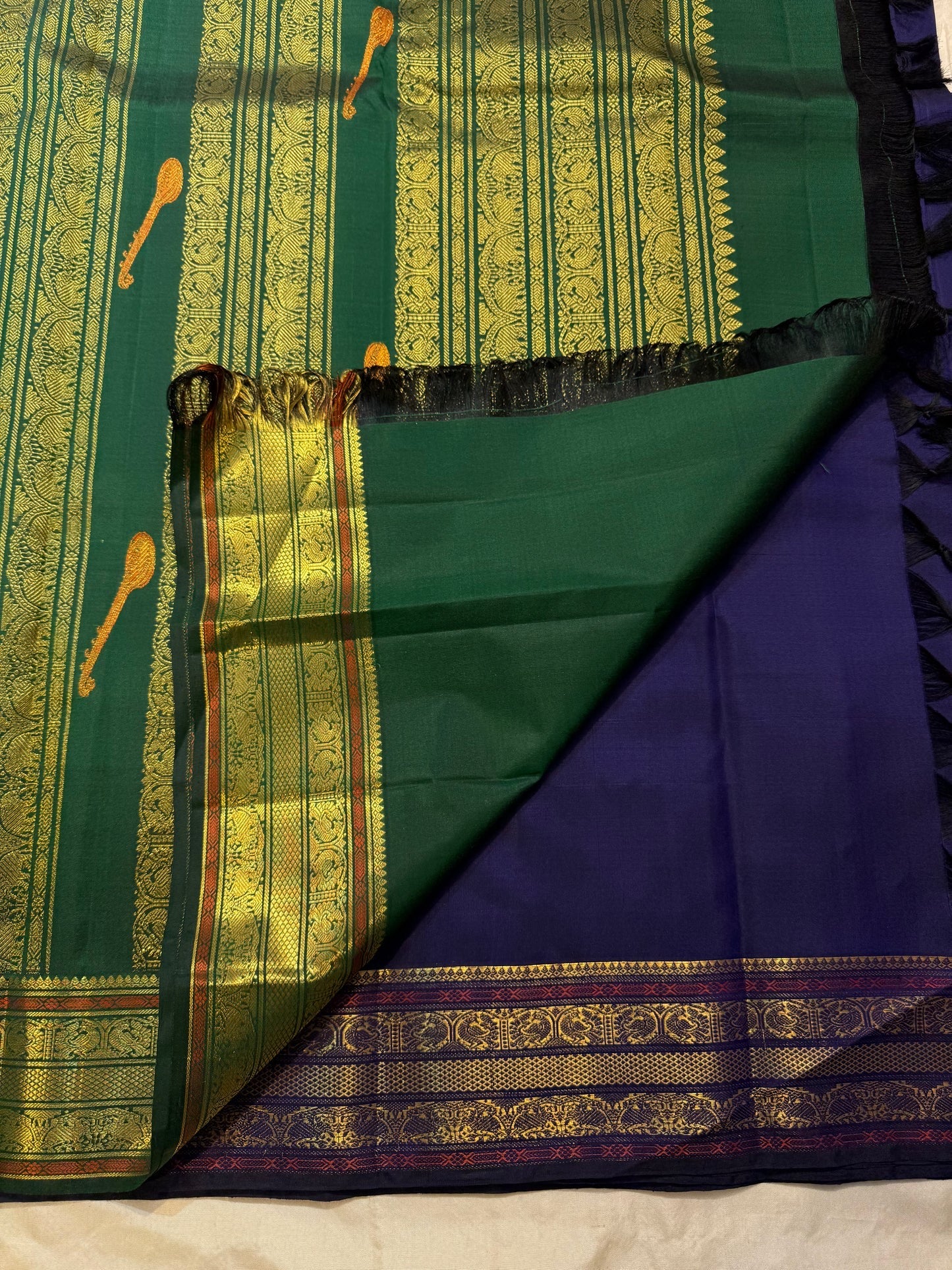 Copper zari tanpura motif detail on bottle green pallu of midnight navy Kanchipuram silk saree — Idam Living