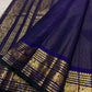 Midnight Kanjipuram saree with cream border and green selvedge