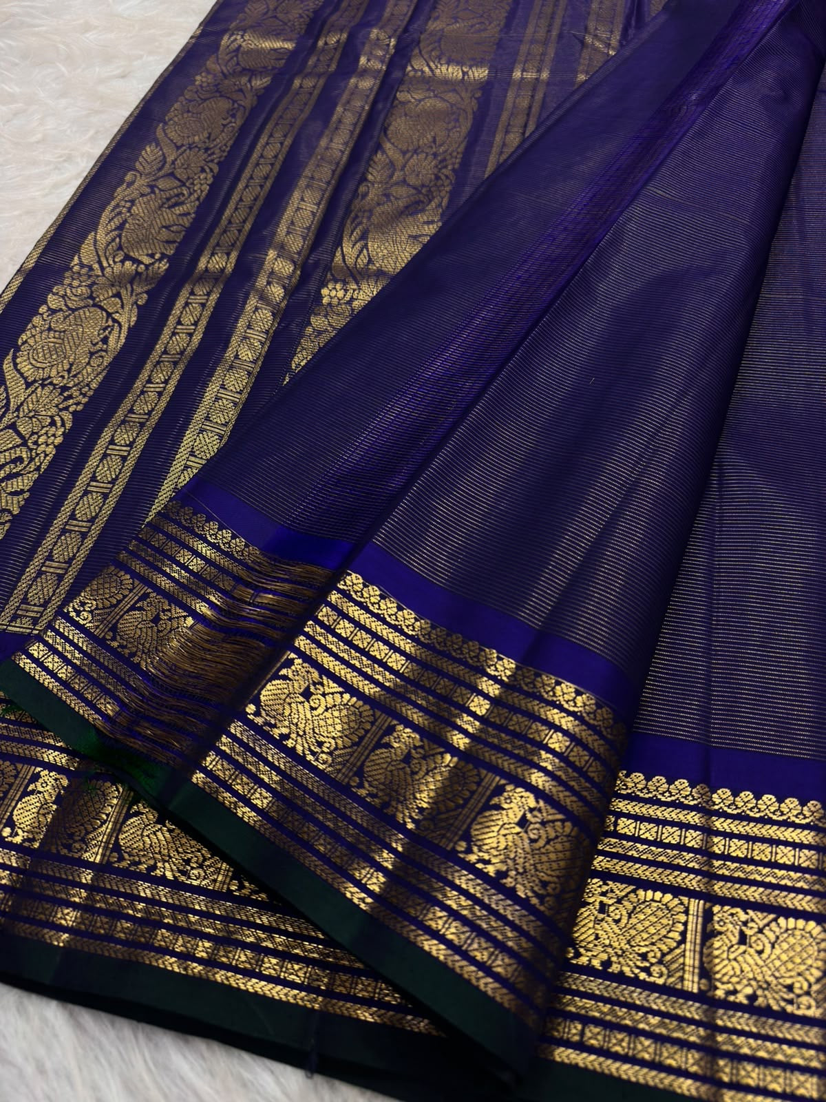 Midnight Kanjipuram saree with cream border and green selvedge