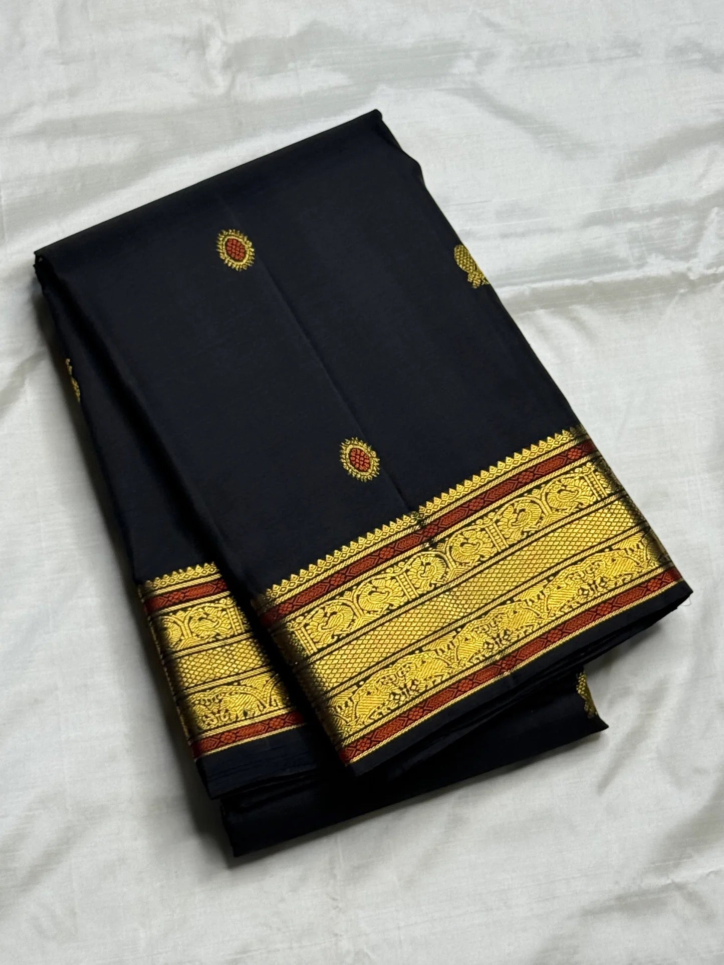 Pure Kanchipuram silk saree with veena-inspired meenakari detailing on the pallu.
