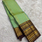 Full view of mint green handwoven Kanchipuram pure silk saree with all-over butta jaal — Idam Living