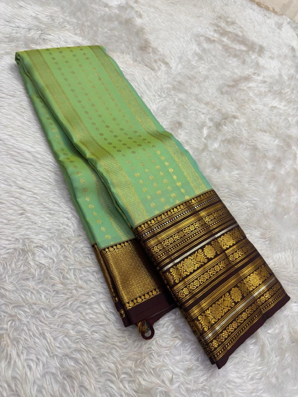 Full view of mint green handwoven Kanchipuram pure silk saree with all-over butta jaal — Idam Living