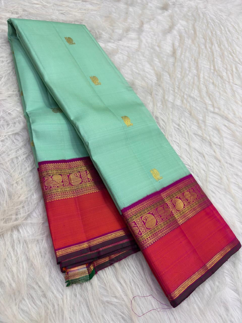 Fresh mint-green Pure Silk Kanjipuram Korvai saree with Mayil and Kamalam buttas and purple coral border.