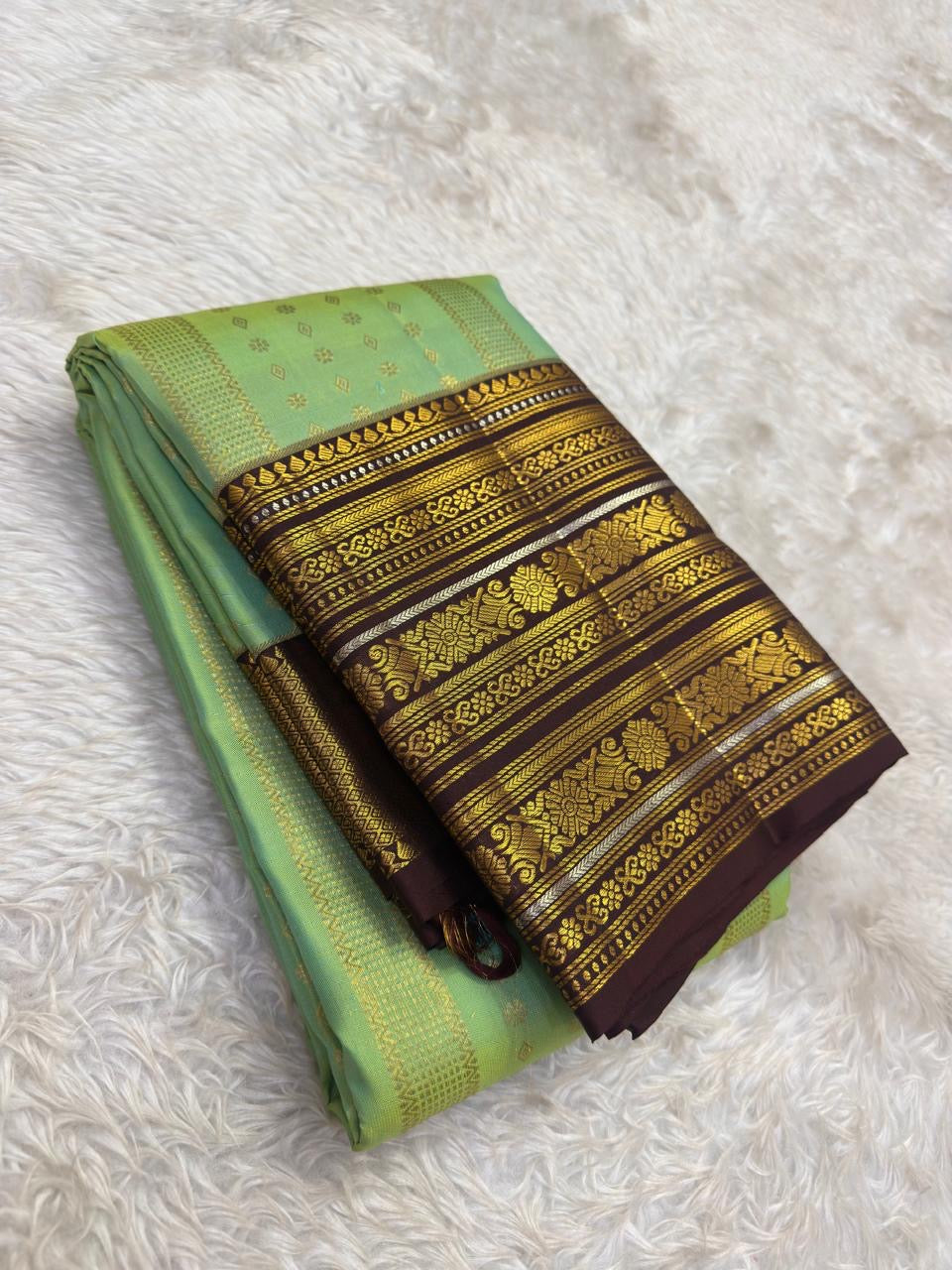 Dense gold zari butta jaal close-up on mint green Kancheepuram pure silk saree — Idam Living