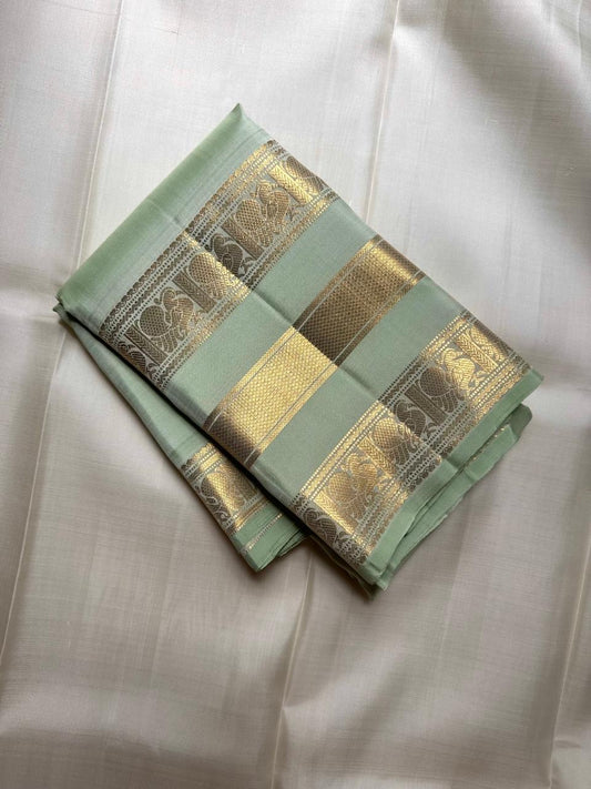 Close-up of gold zari buttas on Mint Green Kanchipuram silk saree body