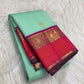 Mint-green Korvai saree showing Vadamalli-purple, coral-orange and gold-zari contrast border.