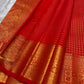 Minute floral gold-zari buttas inside the fine Kattam on Sevappu Red silk.