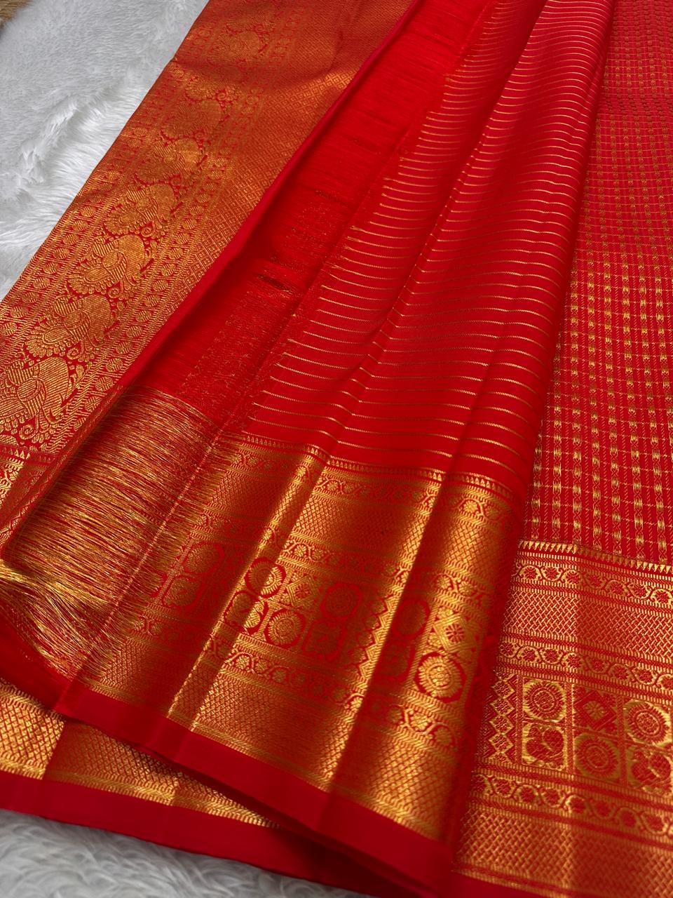 Minute floral gold-zari buttas inside the fine Kattam on Sevappu Red silk.