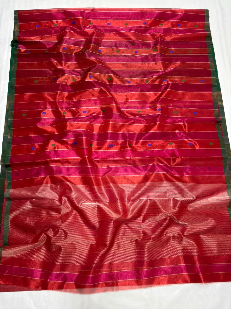 Close view of multicolour cobalt-blue and green buttas woven into Vermilion Red Tissue Silk Chanderi saree
