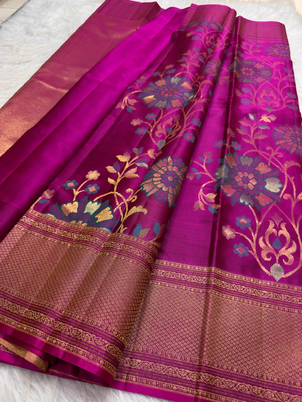 Multicolour floral zari Kanjivaram saree with teal blue peach and gold woven flowers.