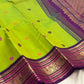 Full view of Parrot Green Kanchipuram Korvai saree showing multicoloured silk-thread buttas and dense Deep Purple gold zari pallu.