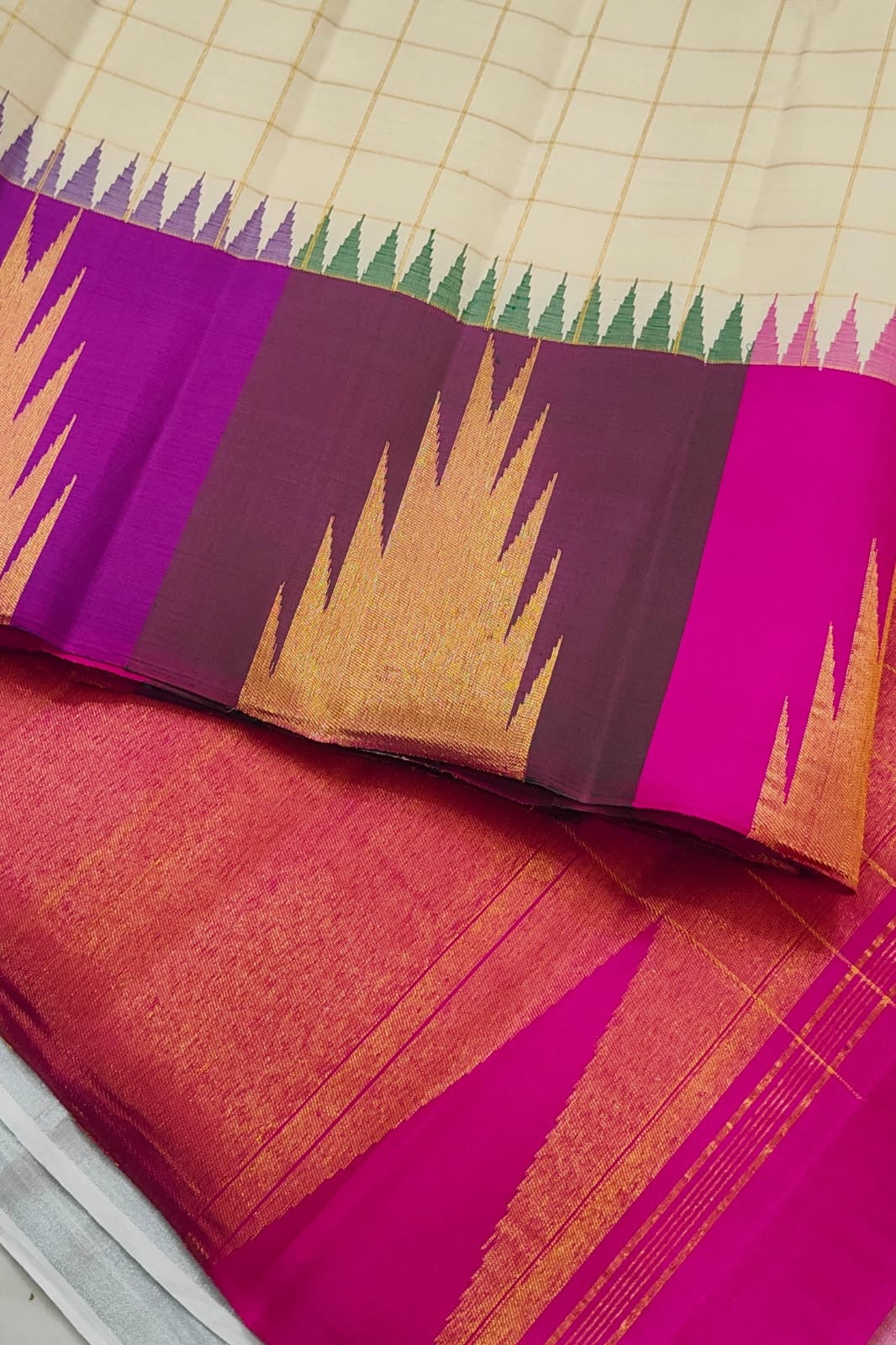 Warm Ivory pure mulberry silk saree with fine gold check pattern and rich multicolour Kanchipuram border.