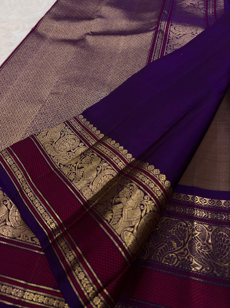 Taupe Kanchipuram silk saree with spaced gold zari buttas and richly woven purple Varisaipet border.