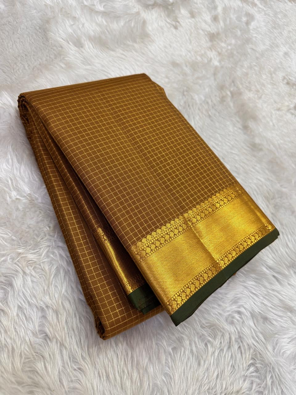 Close-up of mustard amber silk body showing near-tonal Zari Kattam gold grid on thick-ply mulberry silk