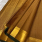 Thick antique gold zari woven border with floral and geometric motifs on mustard amber Kanchi Pattu saree