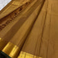 Diagonal zari woven pallu in antique gold cascading across mustard amber silk ground