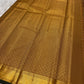 Mustard amber Kanchi Pattu saree folded to show Zari Kattam body and antique gold zari border