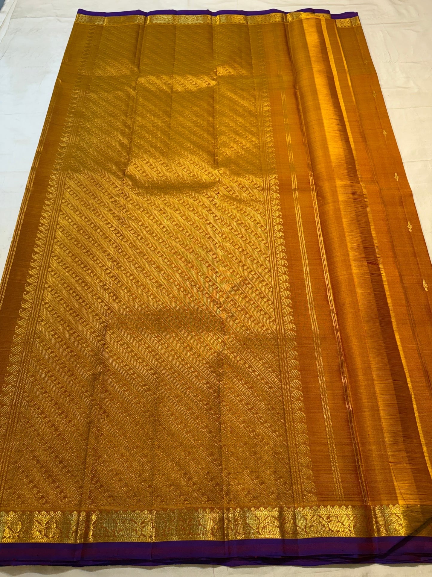 Deep Purple selvedge detail on a Ponvandu Turmeric Yellow Kanjivaram silk saree.