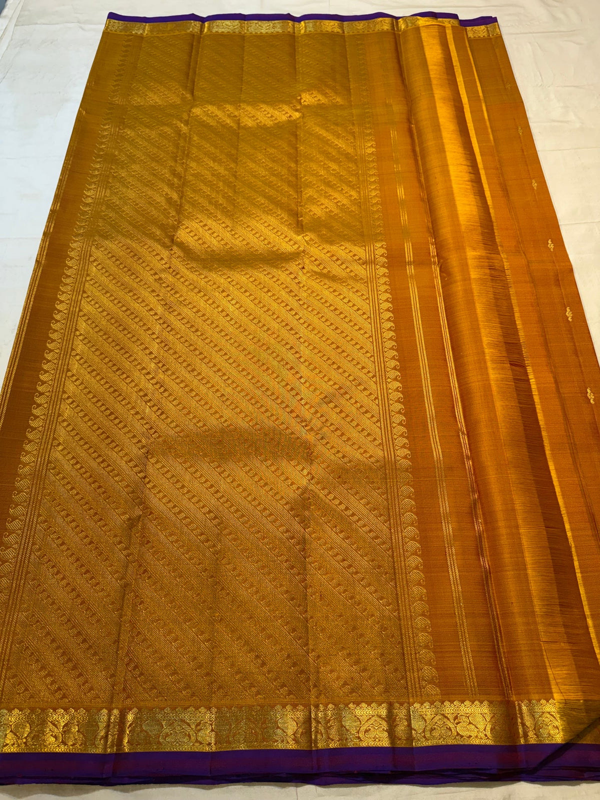 Deep Purple selvedge detail on a Ponvandu Turmeric Yellow Kanjivaram silk saree.